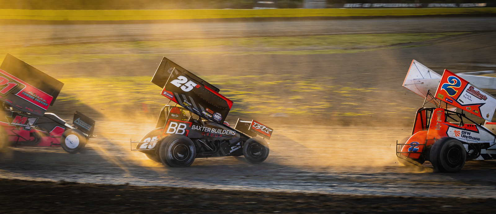 Sprint cars at Big O Speedway in the sunset.