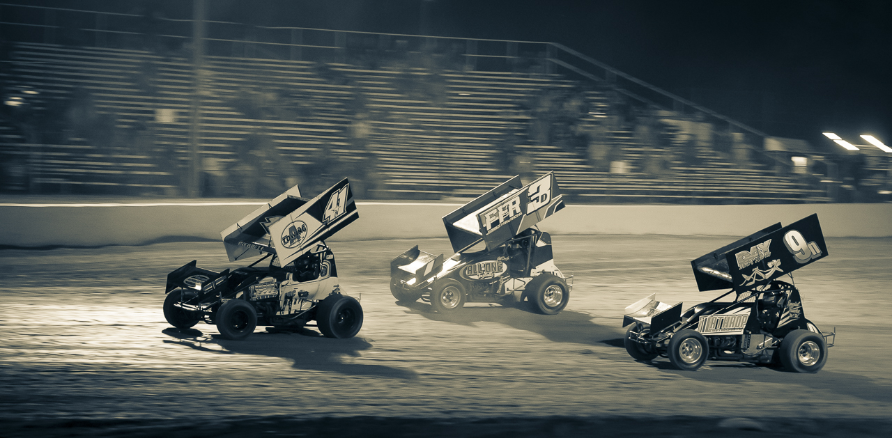 Sprint cars at Big O Speedway in the sunset.